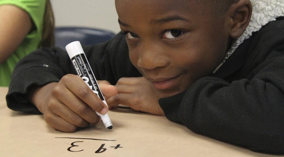 Boy drawing maths on the table